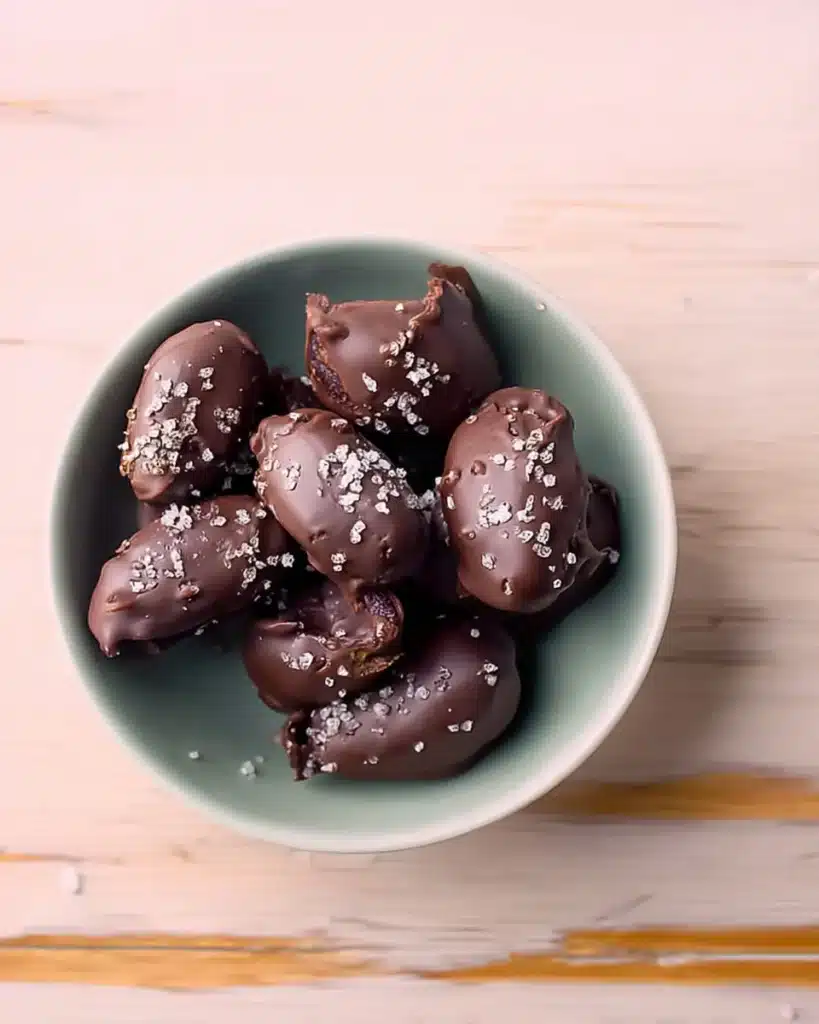 How to Make the Best Tahini Chocolate Date Dessert (Easy, Healthy & Irresistible) 6 Tahini chocolate date dessert with flaky sea salt on top, served in a pastel bowl on a wooden table