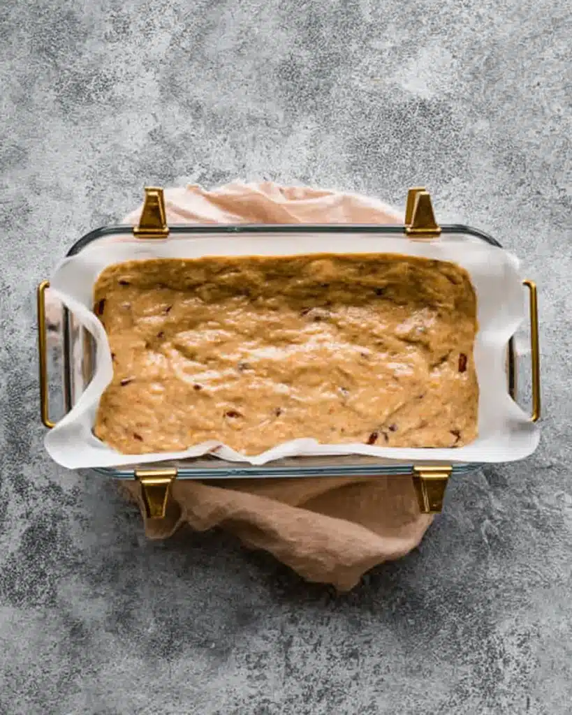 Date Nut Bread Recipe – Easy, Moist, and Nostalgic 8 Date nut bread batter spread in a parchment-lined glass loaf pan, ready to bake