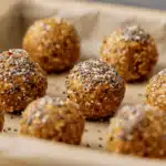 Energy Balls with Dates and Oats and Peanut Butter – Easy Snack 13 Finished energy balls with dates and oats and peanut butter topped with chia seeds on parchment paper