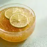 Bariatric Gelatin Recipe golden gelatin bowl with lemon slices, sugar free snack for weight loss