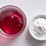 Dr Oz Pink Gelatin Recipe drink with unflavored gelatin powder in a ramekin on a white surface