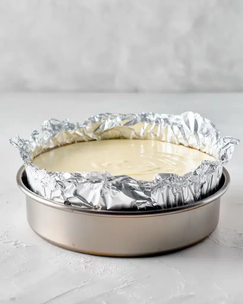 Springform pan in a water bath setup to prevent cracks in baked yogurt cheesecake