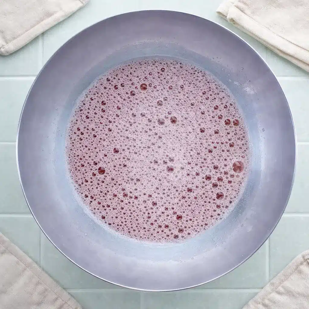 Strawberry Gelatin with Fresh Strawberries, Lime, and Honey 15 Strawberry Gelatin mixture with foam bubbles before skimming and pouring