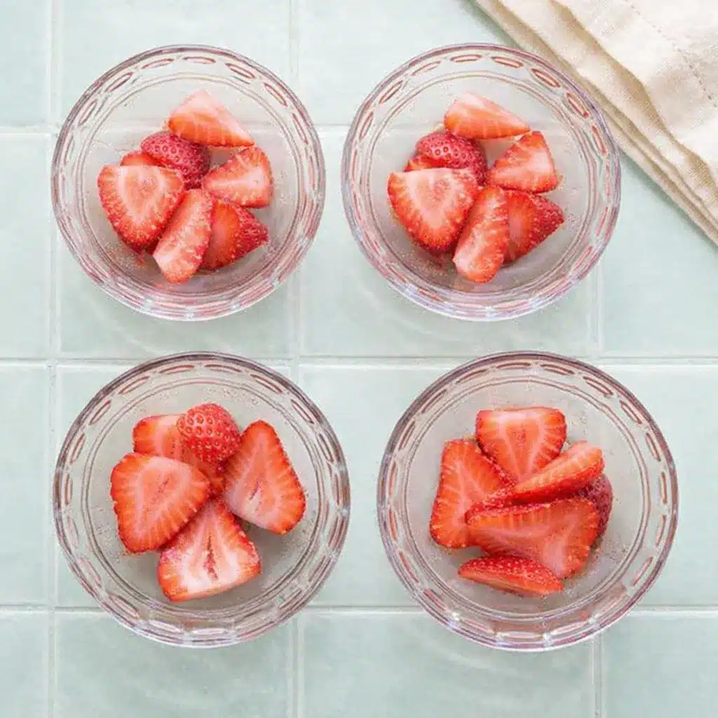 Strawberry Gelatin with Fresh Strawberries, Lime, and Honey 16 Strawberry Gelatin prep bowls filled with sliced strawberries ready for pouring