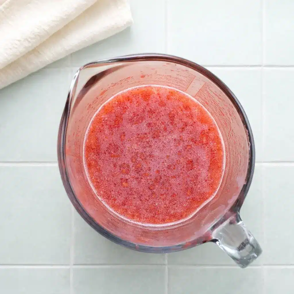 Strawberry Gelatin with Fresh Strawberries, Lime, and Honey 12 Strawberry Gelatin strawberry puree in a measuring jug before cooking and setting