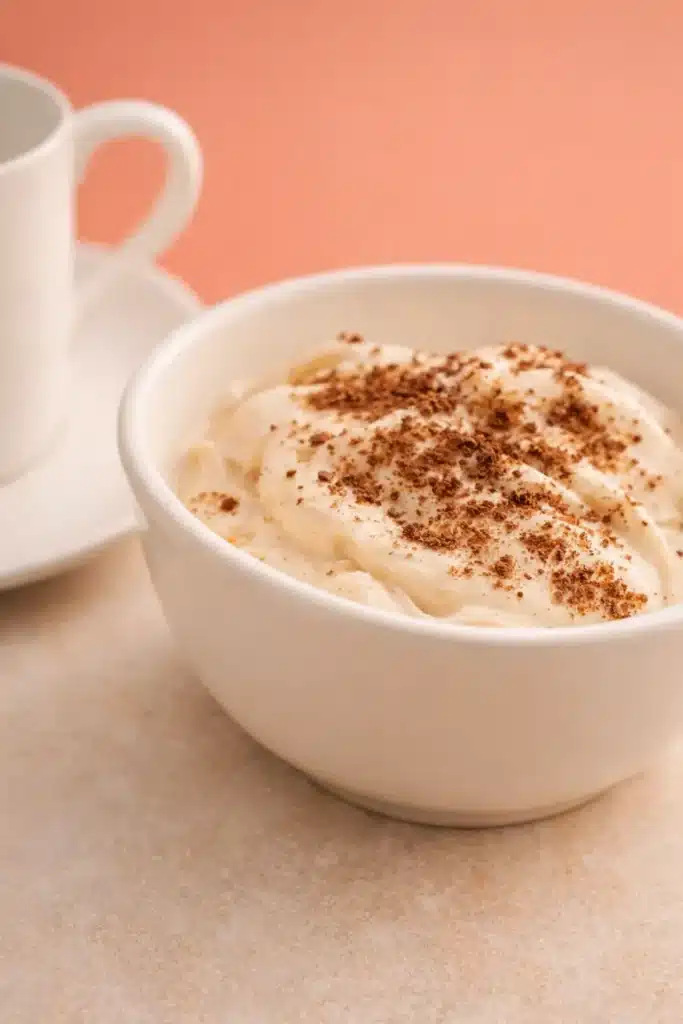 Budwig Cream Recipe That Turns Flax and Fruit Into a Creamy Breakfast 10 Budwig cream topped with cinnamon in a white bowl, a thick creamy Budwig cream breakfast serving idea.