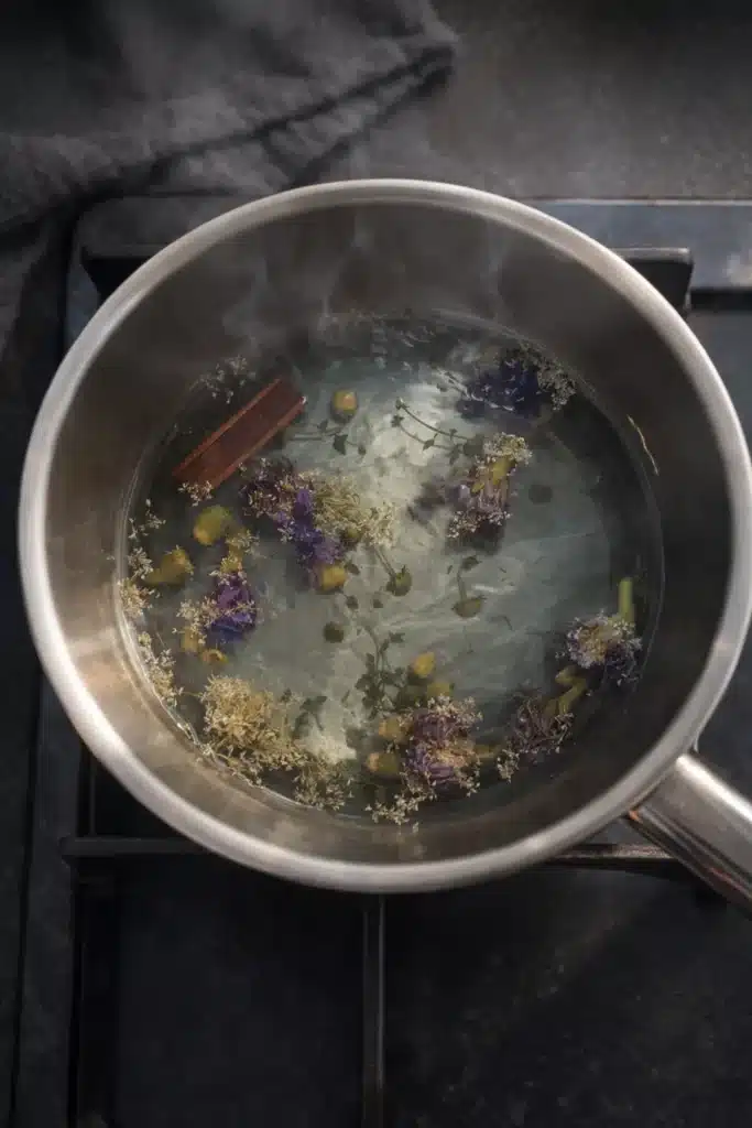 Moon Milk Tea – A Magical Blue Bedtime Drink 10 Moon milk tea steeping with butterfly pea flowers, chamomile, and cinnamon in a saucepan