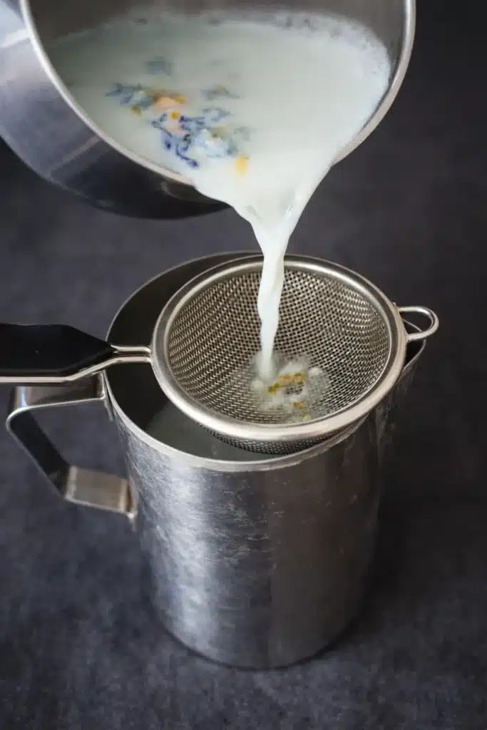 Moon Milk Tea – A Magical Blue Bedtime Drink 12 Moon milk tea being strained through a fine mesh sieve for a smooth butterfly pea milk tea